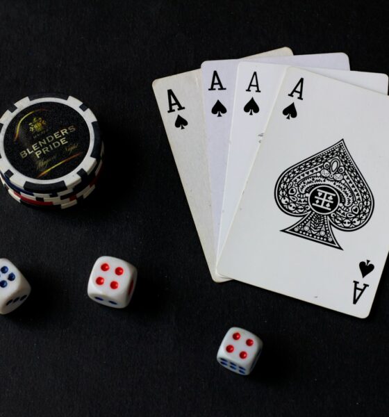 playing cards and dice on a black table